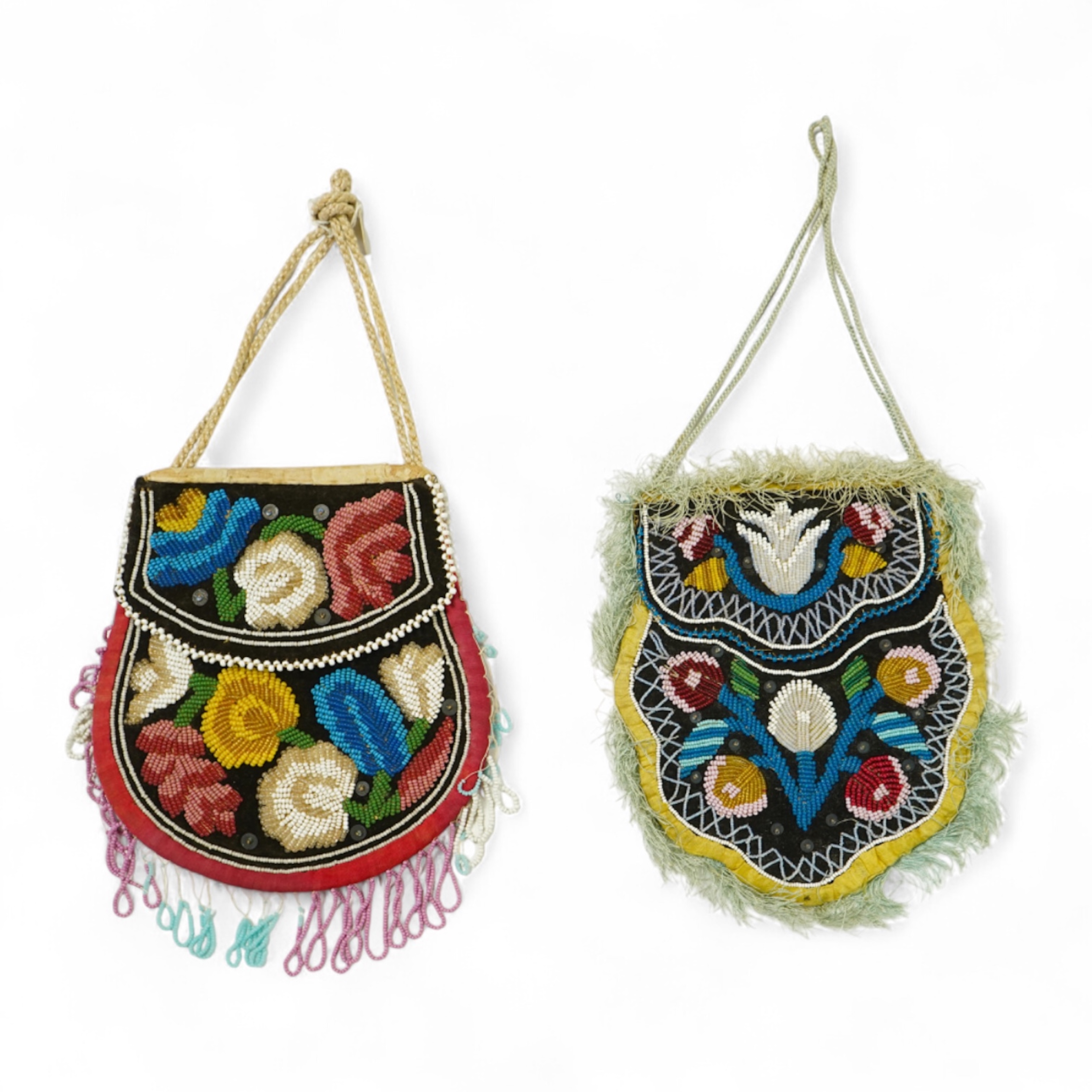 Two Native American Iroquois beaded bags. One edged with fine pale blue silk fringing, the other larger with bead worked fringing. Largest 16.5cm high. Condition - The blue fringed bag has a few sequins missing and the f